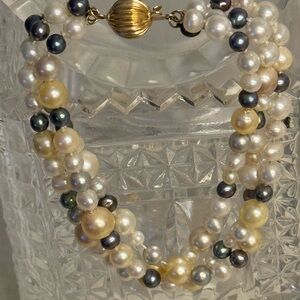 Hand-knotted Cultured Pearl Triple-Strand bracelet with 14k gold clasp.